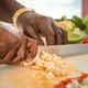 A vendor prepares conch for conch salad, another popular dish in the Bahamas.